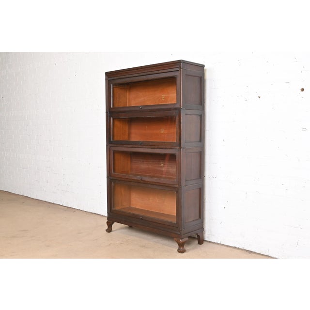A gorgeous antique Arts & Crafts mahogany four-stack barrister bookcase By Macey USA, circa 1920s Measures: 35.25"W x...