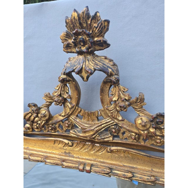 This is a hand carved gilt wood french mirror with intricate details. The gold leafing is distressed and adds so much...