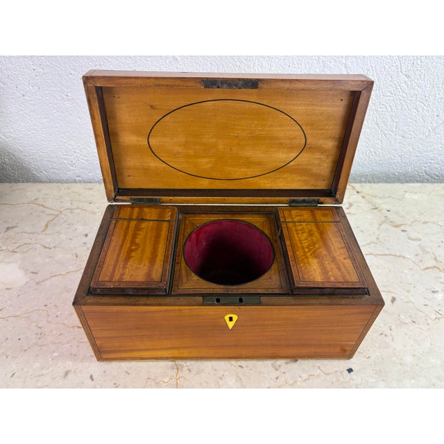 This is a mid 19th century American made satin wood tea caddy. This tea caddy has a beautiful banded inlaid edge with its...