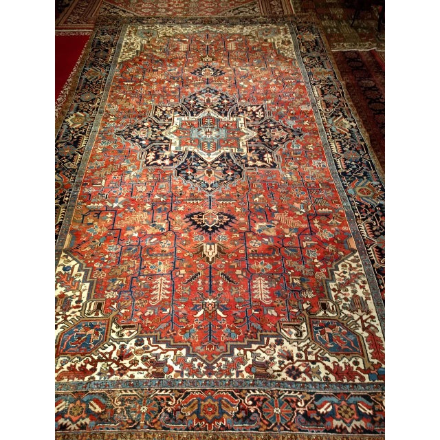 An outstanding oversized Persian Heriz Karajah rug from the early 1900s, handwoven in the Karajah village of Northwest...