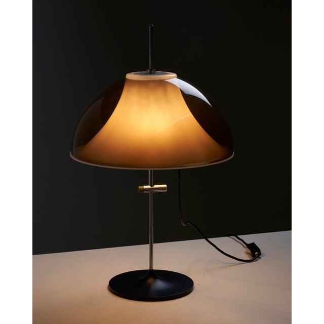 Transport yourself back to the iconic midcentury period with this extraordinary table lamp that embraces the captivating...