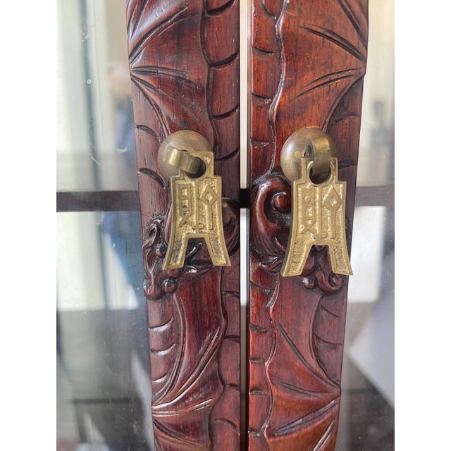 Gorgeous antique Qing Dynasty extensively carved Chinese display case with mirror. Two dragons carved at the crown .From...