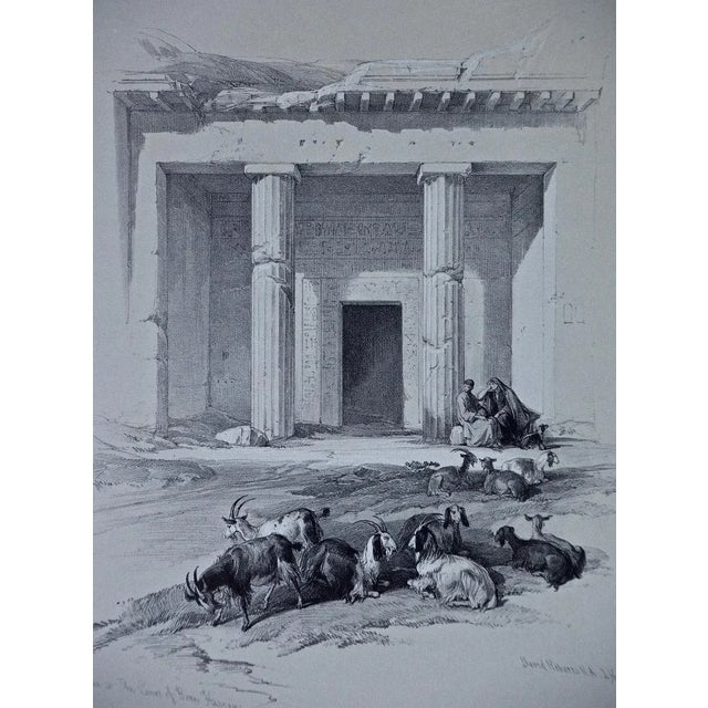"Entrance To The Caves Of Beni Hasan" is a 19th century half-folio sized tinted duo-tone lithograph from the "The Holy...