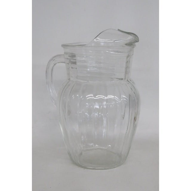 This gorgeous Depression Era Pitcher is made of glass. This stunning clear glass Pitcher has lovely vintage design; it...