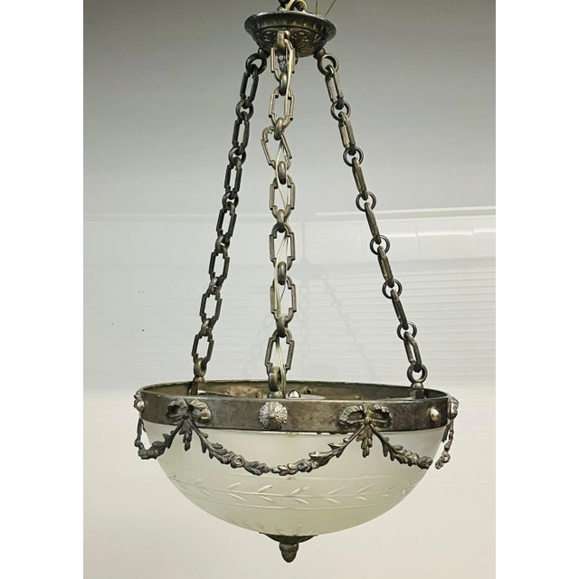 Antique bronze chandelier with a nickel finish and a cut glass shade. The canopy is labeled Bronze Veritable....