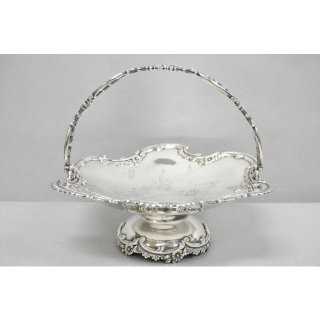 Antique Meriden Silver Plated Floral Repousse Pedestal Base Brides Wedding Basket with Pivoting Handle. Circa Early 20th...