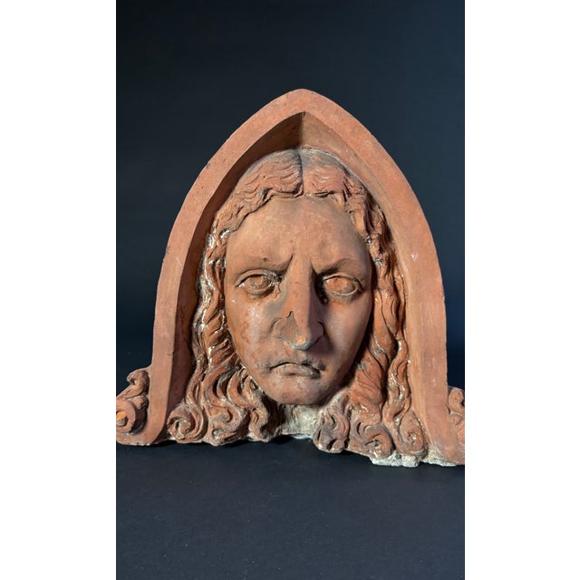 This sculpture depicts a 19th-century terracotta acroterion with a thick edge, from Lombardy. The figure represents a...
