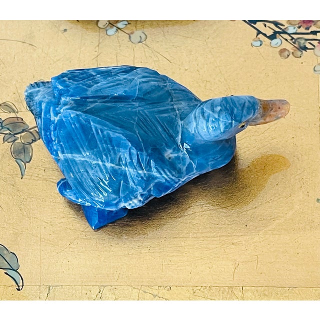 Vintage Chinese carving figurine of a blue sodalite stone duck figurine on a wood carved stand.