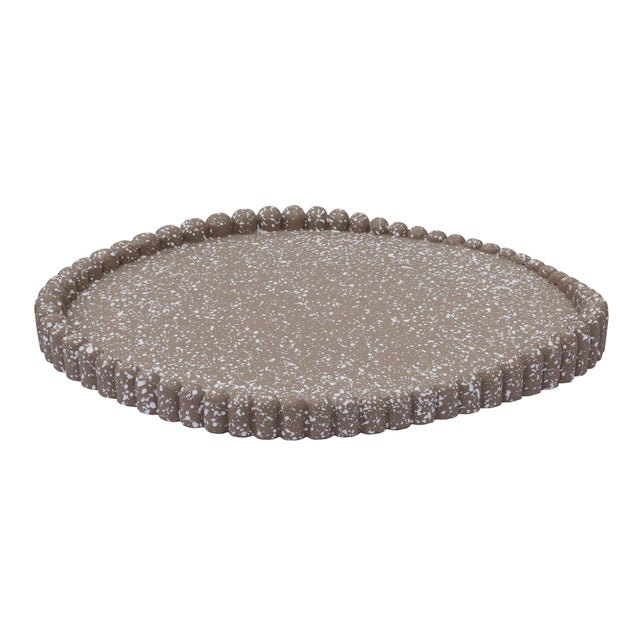The Alna Catchall Tray channels a wabi-sabi aesthetic with organic curves, a sculptural beaded edge and modern texture,...