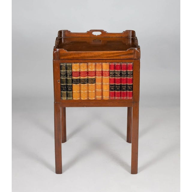 Mahogany fixed tray-top side table with carrying handles, leather book spine door, on straight chamfered legs.