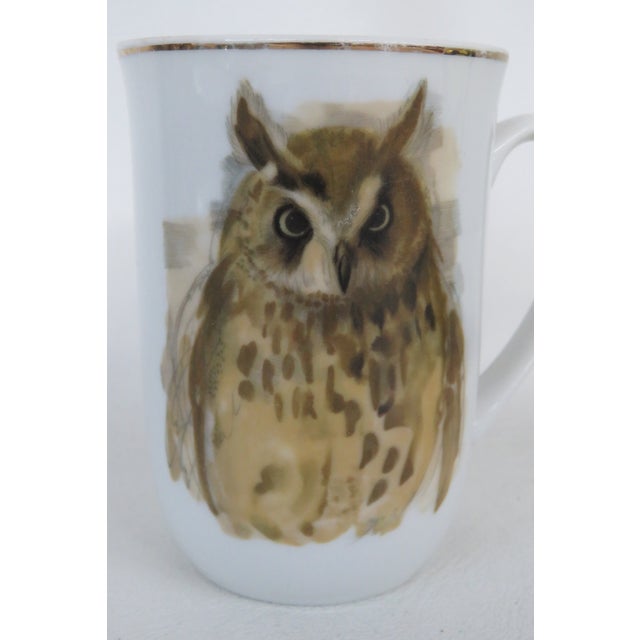 This lovely Enesco mug is made of porcelain. This piece is part of Enesco's line incorporating paintings by Hans Paul...