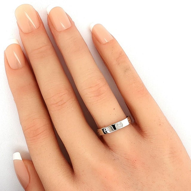 This authentic Cartier band ring from the iconic Love collection is crafted in solid 18k white gold with a high polished...
