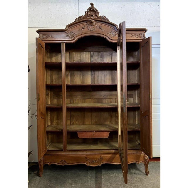 This Louis XV style bookcase, crafted from finely carved walnut, exudes authentic charm and makes a striking decorative...