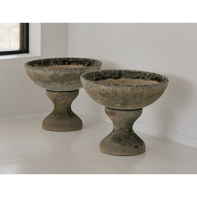 Pair of concrete planters, France. These unique shaped concrete platers are made up of two-pieces, featuring a wide,...