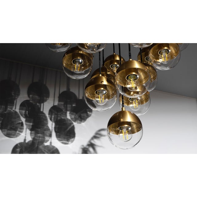 This hovering assemblage of radiating elements glimmers with vital energy. Inspired by elemental shapes, nineteen half...