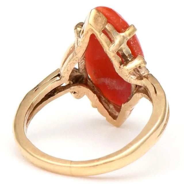 Exquisite coral is the magnificent centerpiece of this alluring vintage coral ring. An elegant 14K yellow gold design...