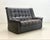 A generously sized vintage leather sofa in dark brown leather, dating from the late 1970s. The design exemplifies the...