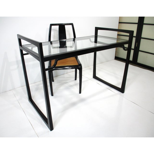 A very well crafted wooden Mid Century desk with glass inserted top with matching chair and a woven seat for comfort . A...