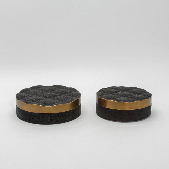 The "Coco" round box in black shagreen with bronze patina brass exudes unparalleled luxury and craftsmanship. Its...