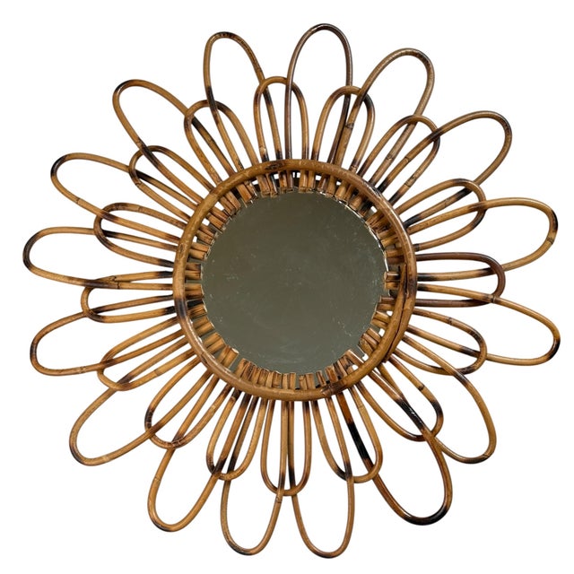 1950s rattan sunburst mirror. The mirror is original. Made in the south of France.