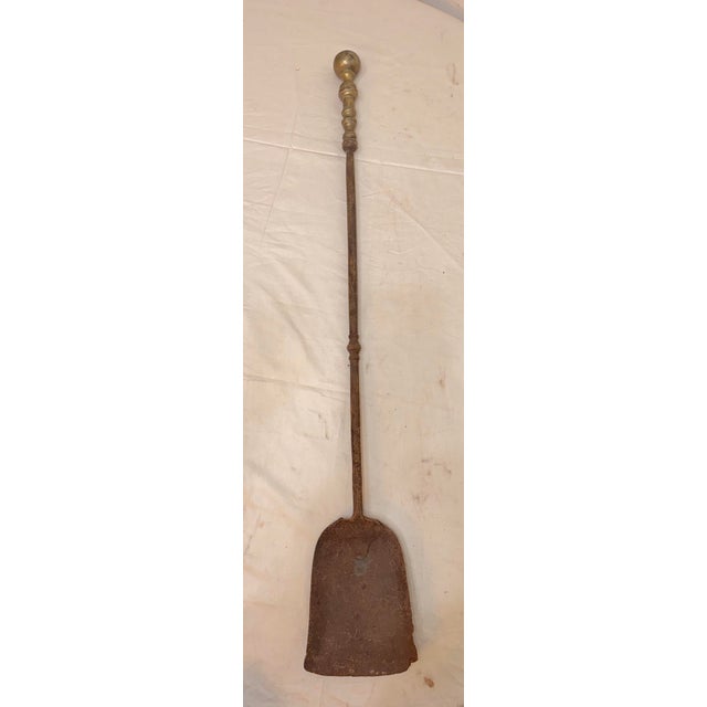 Up for sale is a rare antique 18th century wrought iron and brass English fireplace shovel. The shaft and blade are...