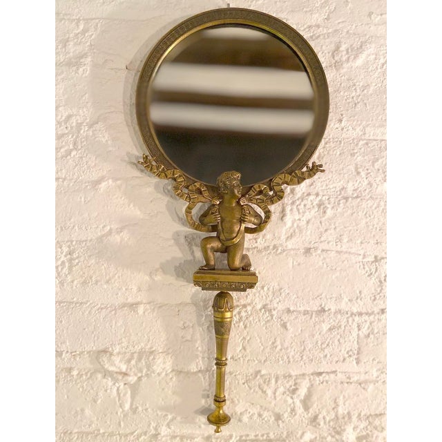 This authentic 19th Century French hand vanity mirror is a finely crafted and sculptural decorative object, showcasing the...