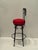 Sensational set of 4 black wrought iron vintage barstools having fleur di lis decorated backs and striking round red...