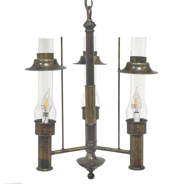 This handsome chandelier is a classic arts & crafts or mission style fixture with three arms each holding a lamp within a...