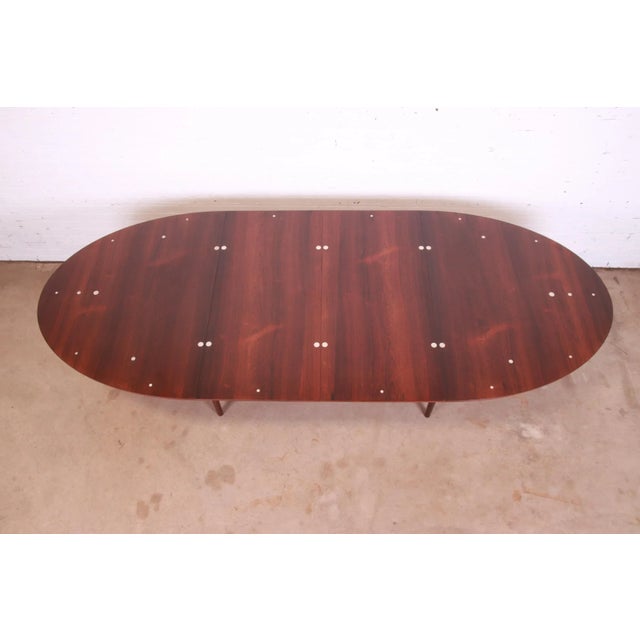 An extremely rare and exceptional mid-century Danish Modern "Judas" extension dining table. This iconic table was designed...