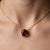 Round Garnet Pendant Necklace – January Birthstone This elegant necklace showcases a radiant garnet gemstone, admired for...