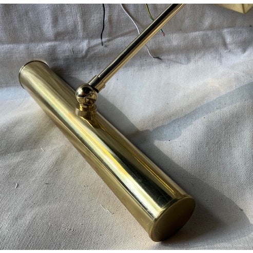 Hard-wired wall-mounted picture light from Besselink & Jones, in polished brass.