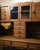 Beautiful antique oak Hoosier cabinet featuring original hardware, flour bin, multiple storage compartments, glass-front...