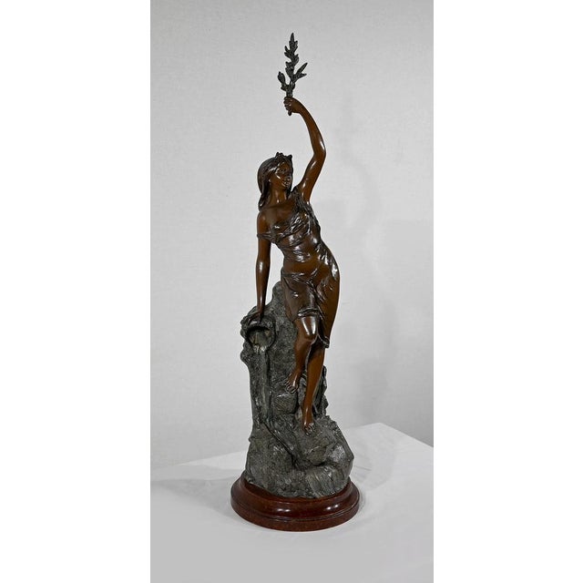 Large print in patinated tricolor regula, representing a young woman holding an olive branch above her head. Lightly...