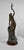 Large print in patinated tricolor regula, representing a young woman holding an olive branch above her head. Lightly...