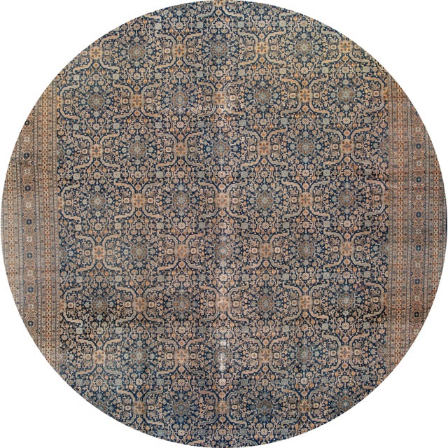 A beautiful hand-knotted Tabriz with the blue and tan field in a geometric design. This beautiful design rug will make...