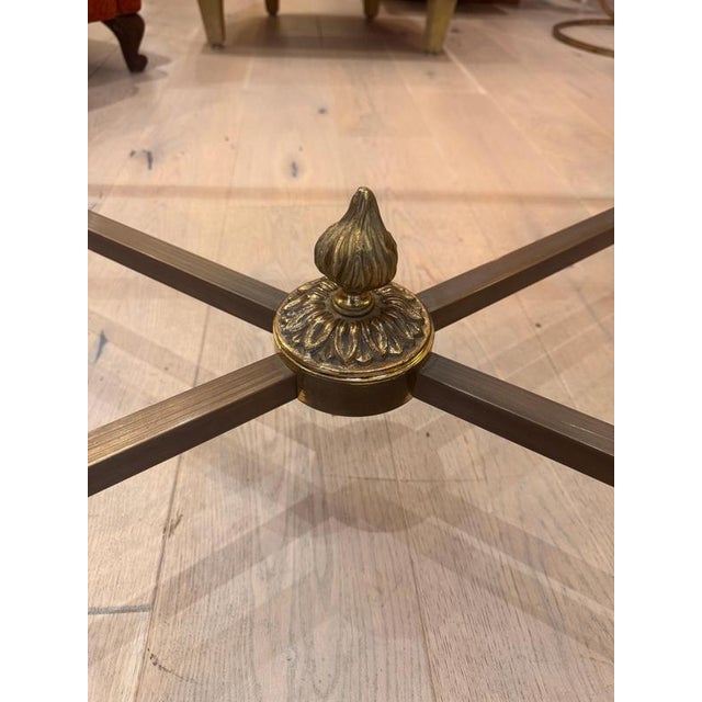 An exceptional large coffee table in patinated bronze and brass with 10mm thick toughened glass top. Solid cast bronze and...