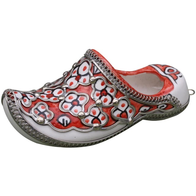 Handcrafted Moroccan ceramic babouche with hand-painted floral pattern and intricate silver inlay. This beautiful accent...