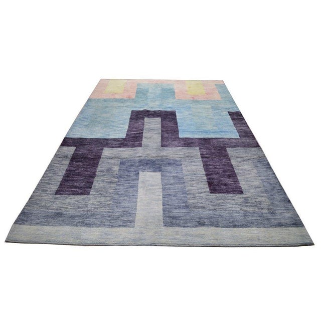 Hand-knotted with care using traditional rug-making techniques, this wool rug blends timeless craftsmanship with a modern...