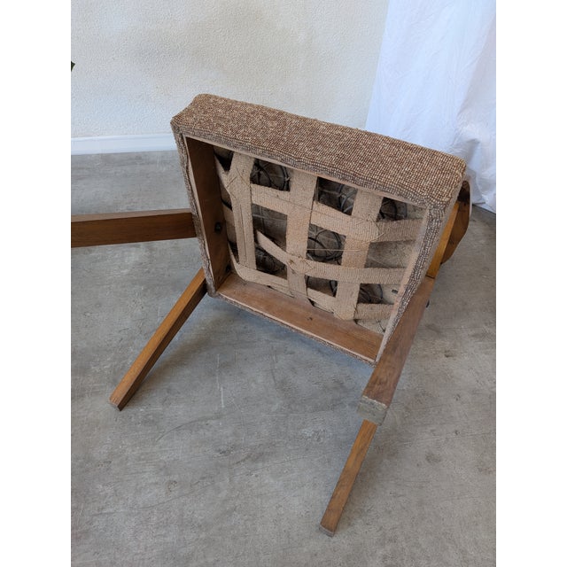 Unique vintage cocktail armchair from the 1970s. It features a low profile with straight, geometric lines typical of...