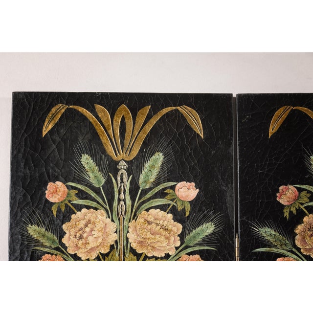 A black lacquer four-panel Chinese screen with majestic floral painted décor and crackle finish. Captivating our attention...