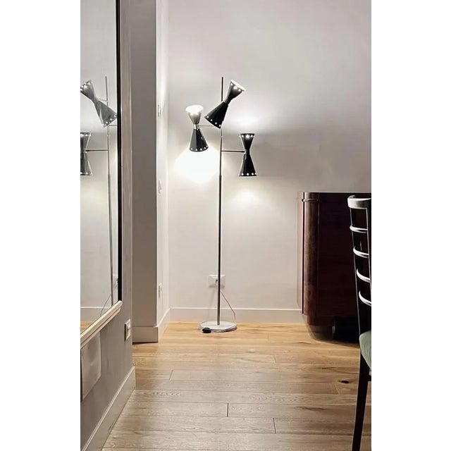 Rare floor lamp from Stilnovo, the cones can rotate and be inclined, the structure and nickelated, the cones are black...