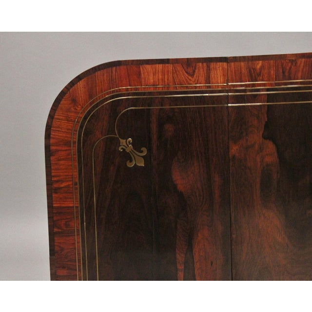 A superb quality early 19th Century rosewood and brass inlaid sofa table, having a wonderfully figured top, crossbanded...