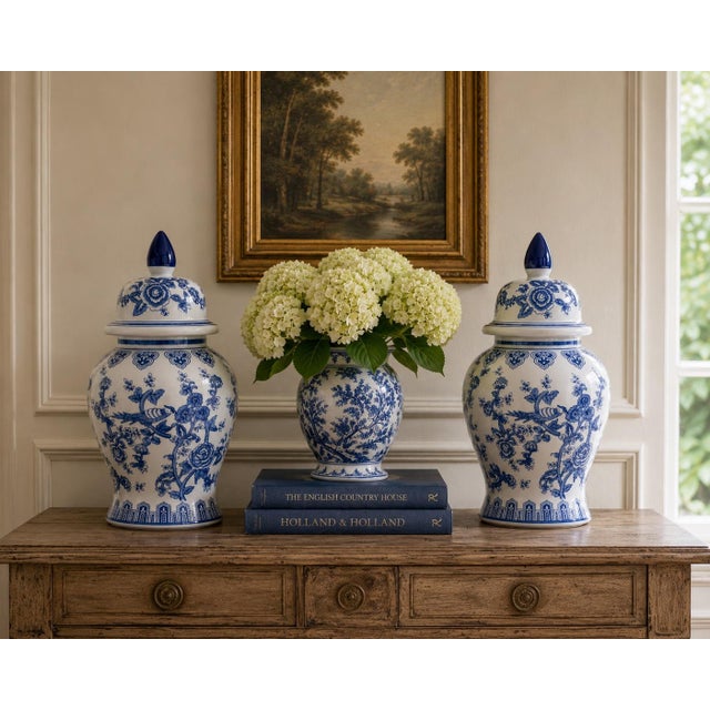 A classic pair of blue and white ginger jars, decorated throughout with delicate bird and flowering branch motifs. The...