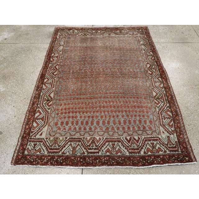 This mid-20th-century Persian Malayer accent rug presents a finely patterned allover composition across a muted blue...