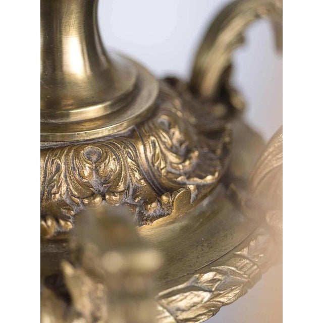 Luxurious antique chandelier made of gilded bronze with rich floral decoration. The chandelier is restored: new power...