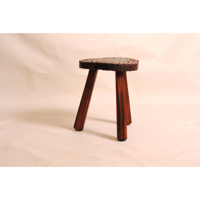 Three-legged farmhouse stool in varnished wood with brass nails A charming solid wood stool with a rustic and authentic...