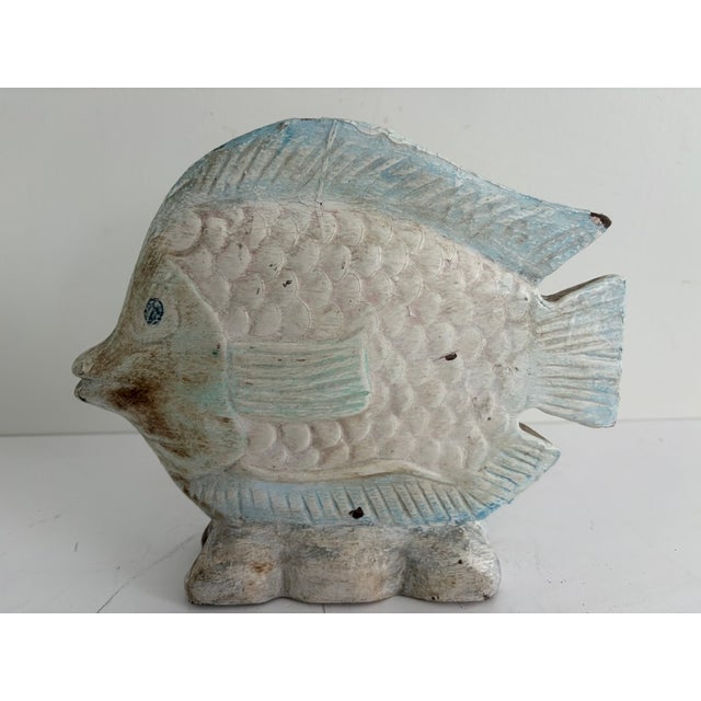 Vintage hand-carved wooden fish sculpture with a soft blue and white painted finish. Likely dating to the 1970s–80s, this...