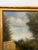 This 19th century French oil on canvas depicts a tranquil woodland scene with a road winding through tall trees, painting...