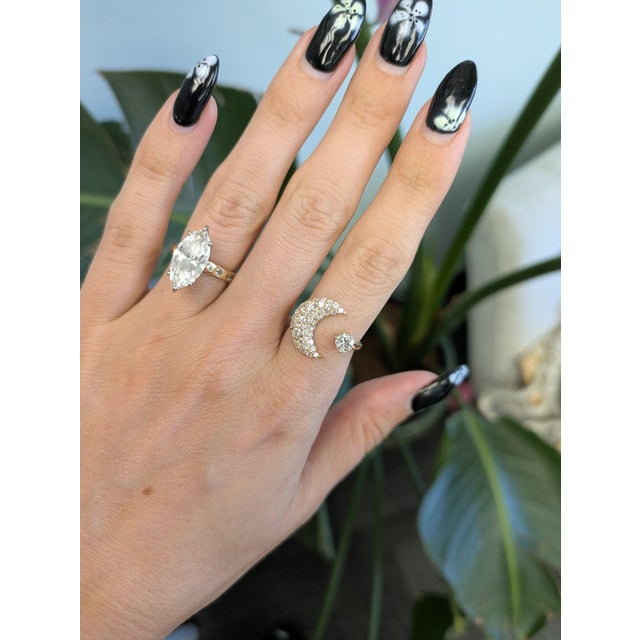 Forty-six round lab grown diamonds totaling 1.26 carats sparkle across this solid 14K yellow gold ring, anchored by a...