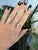 Forty-six round lab grown diamonds totaling 1.26 carats sparkle across this solid 14K yellow gold ring, anchored by a...